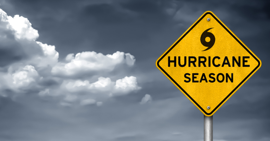 A street sign against a dark, cloudy background reading Hurricane Season