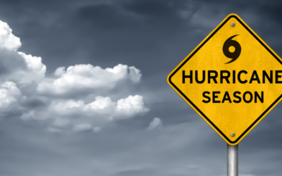 A street sign against a dark, cloudy background reading Hurricane Season