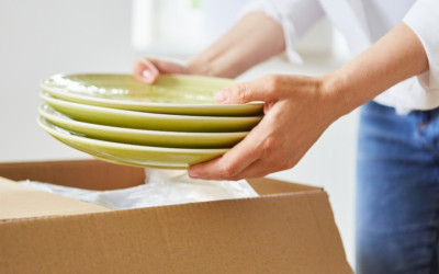 woman packing green dishes in a box