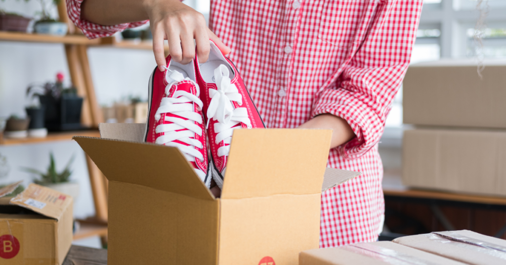 putting red shoes into a box