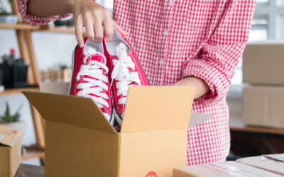 putting red shoes into a box